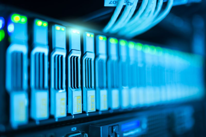 Rij hot-swap schijfslots in een serverrack, blauw verlicht met groene status-leds